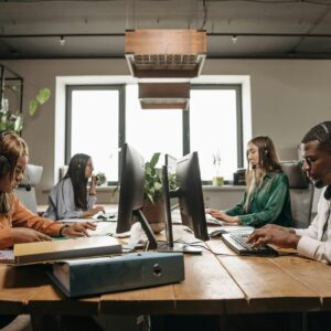 A diverse group of employees collaborating with headsets in a modern office setting.